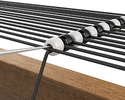 A row of beads strung across the warp threads using a needle